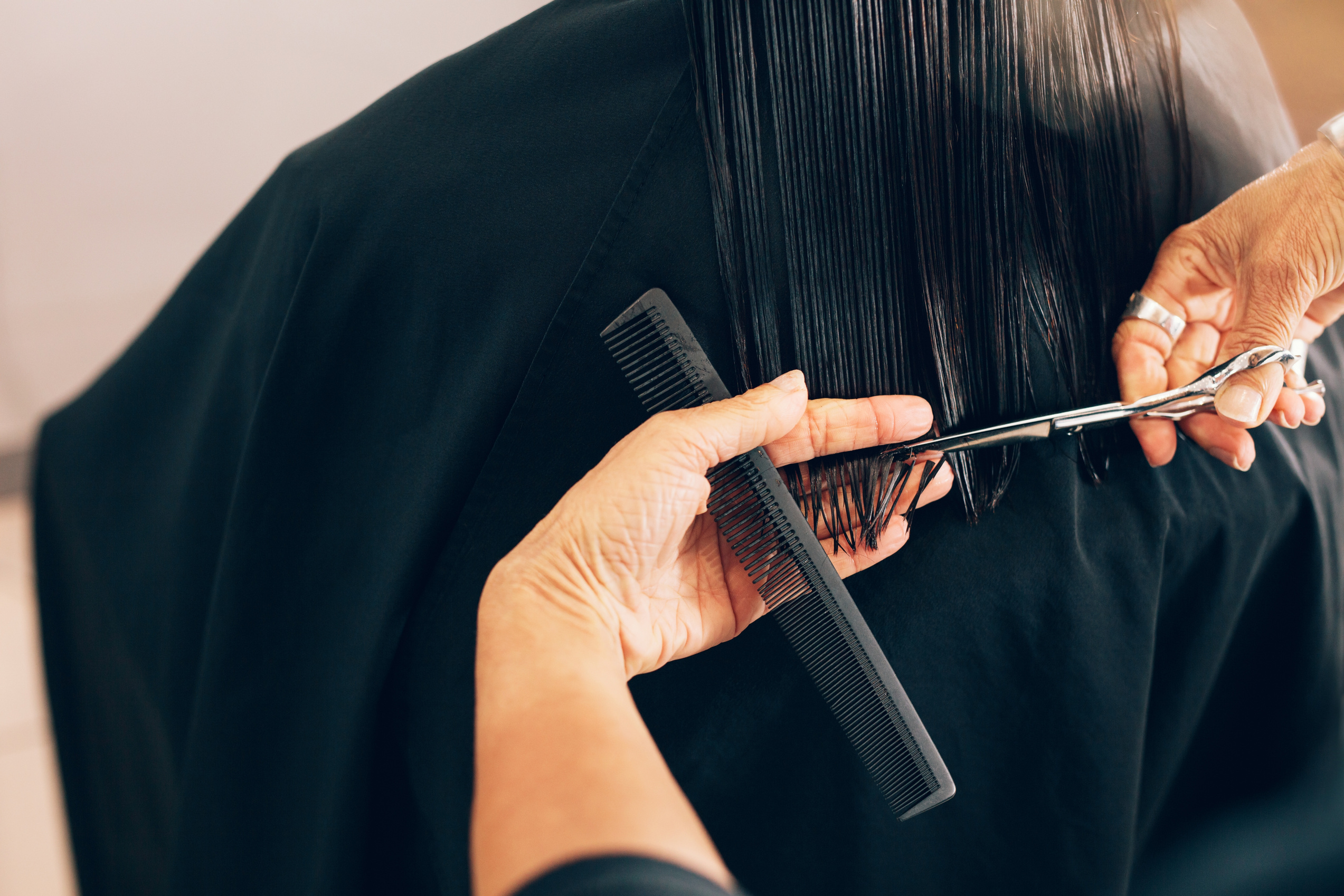 Hairdresser Cutting Client's Hair 